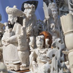 Ivory sculptures are on display before being crushed, Thursday, Aug. 3, 2017, in New York's Central Park. The New York State Department of Environmental Conservation destroyed illegal ivory confiscated through state enforcement efforts. (AP Photo/Mary Altaffer)