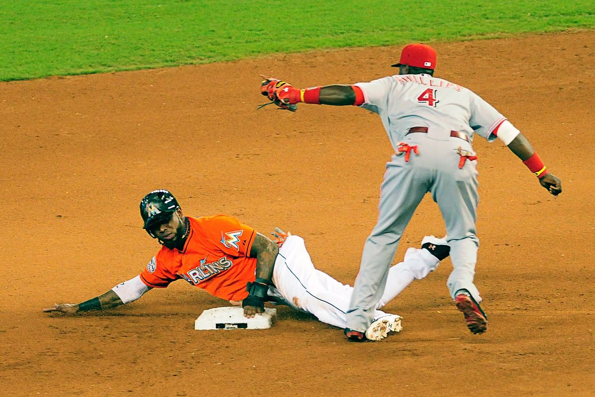 MIAMI, FL - SEPTEMBER 16: Jose Reyes (L) of the Florida Marlins is tagged out by Brandon Phillips #4 of the Cincinnati Reds for an out at Marlins Park on September 15, 2012 in Miami, Florida. (Photo by Jason Arnold/Getty Images)