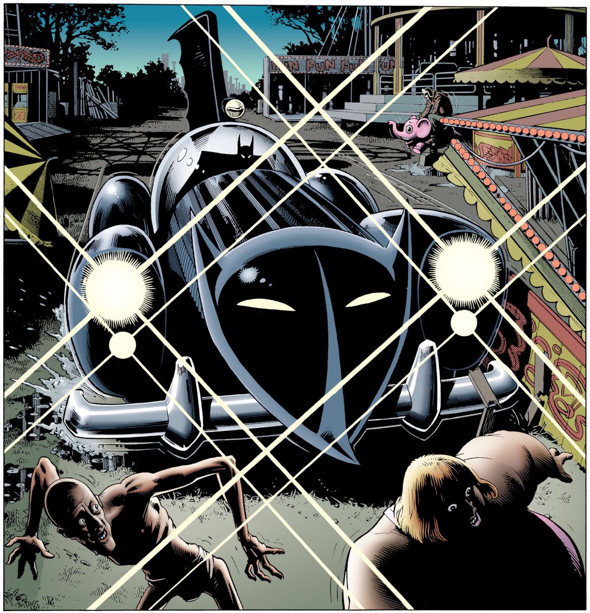 Batman pulls the Batmobile into an abandoned carnival, sending sideshow performers scattering. The car is clearly a modified mid-century roadster, with a big stylized bat-face on the front of it and a huge, scalloped vertical fin sprouting from its back. Seen in Batman: The Killing Joke, DC Comics (1988). 