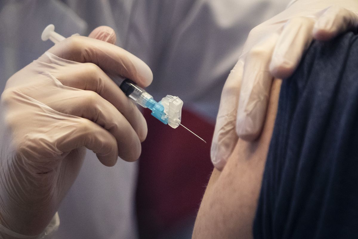 A union member receives a COVID-19 vaccine shot on the South Side in March.