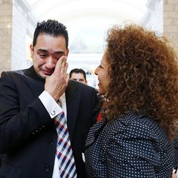 New citizen Juan Rodriguez wipes a tear following a naturalization ceremony at the Capitol in Salt Lake City, Monday, March 28, 2016. At right is his mother, Rose Mary Skinner.