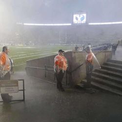 BYU and Texas fans take cover from the rain as a storm passes over Provo prior to game time Saturday, Sept. 7, 2013 at LaVell Edwards stadium. 
