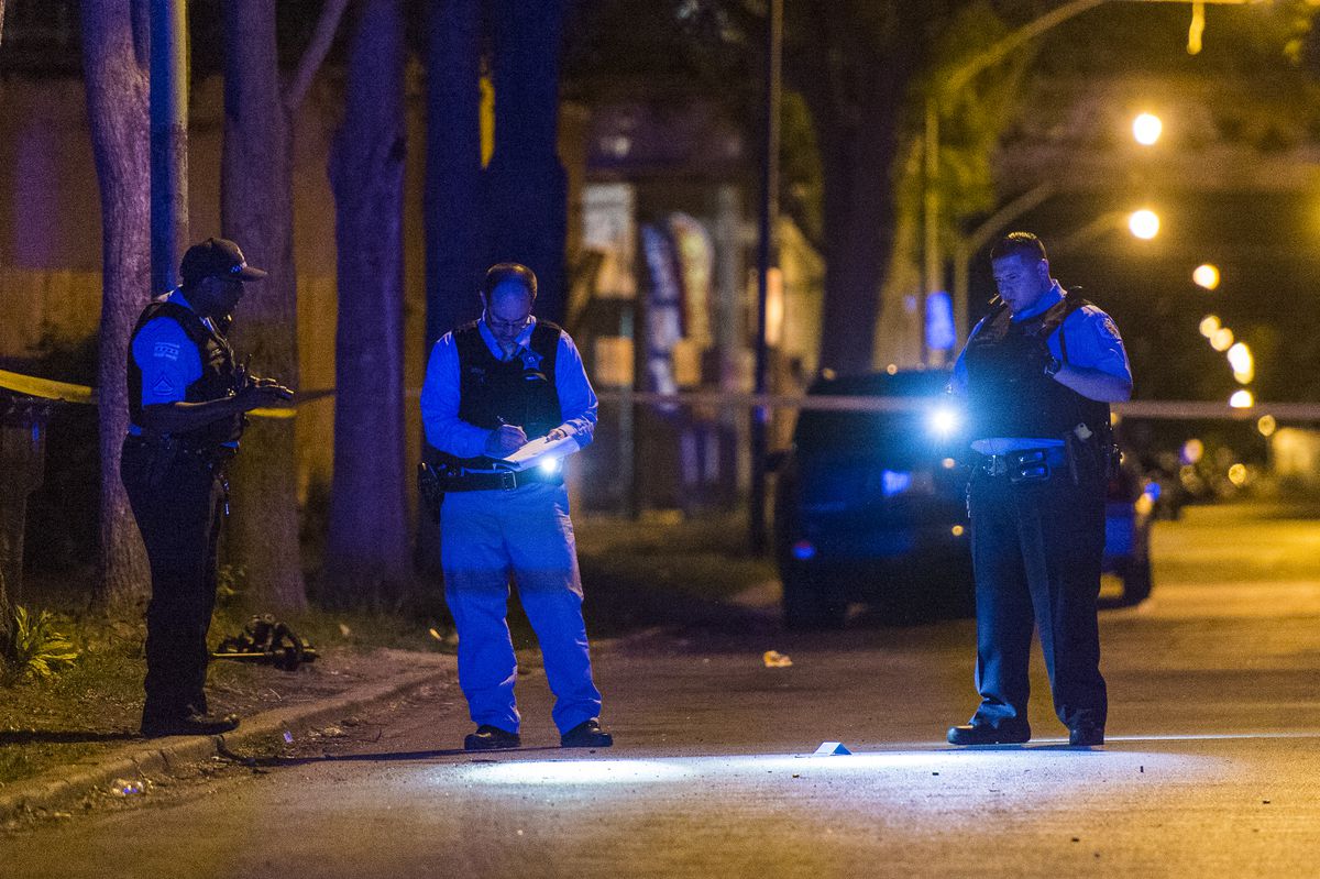 Police investigate a scene where a person was shot in the leg Sunday night in the 6200 block of South Vernon Avenue. | Tyler LaRiviere/Sun-Times