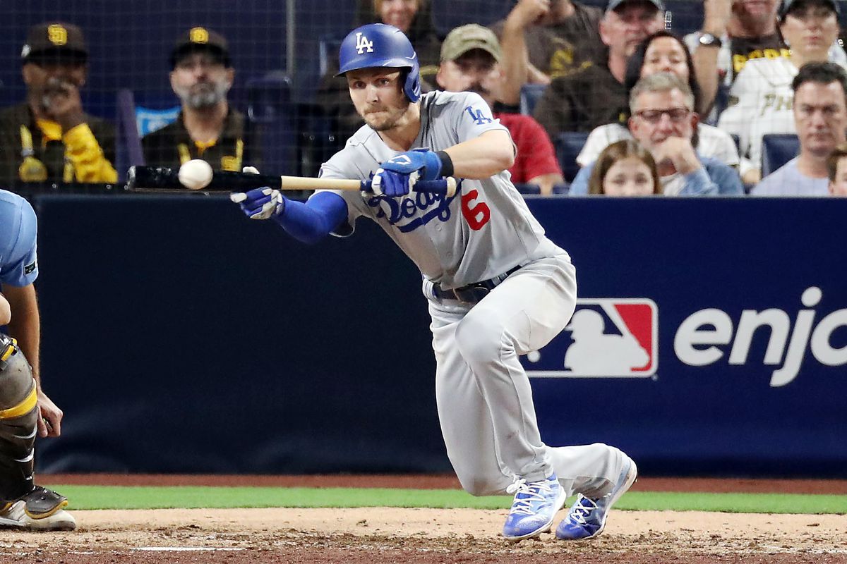 Trea Turner #6 of the Los Angeles Dodgers bunts for a single during the seventh inning against the San Diego Padres in game four of the National League Division Series at PETCO Park on October 15, 2022 in San Diego, California.