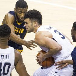 Brigham Young guard Elijah Bryant (3) drives between two Coppin State players during an NCAA college basketball game in Provo on Thursday, Nov. 17, 2016.