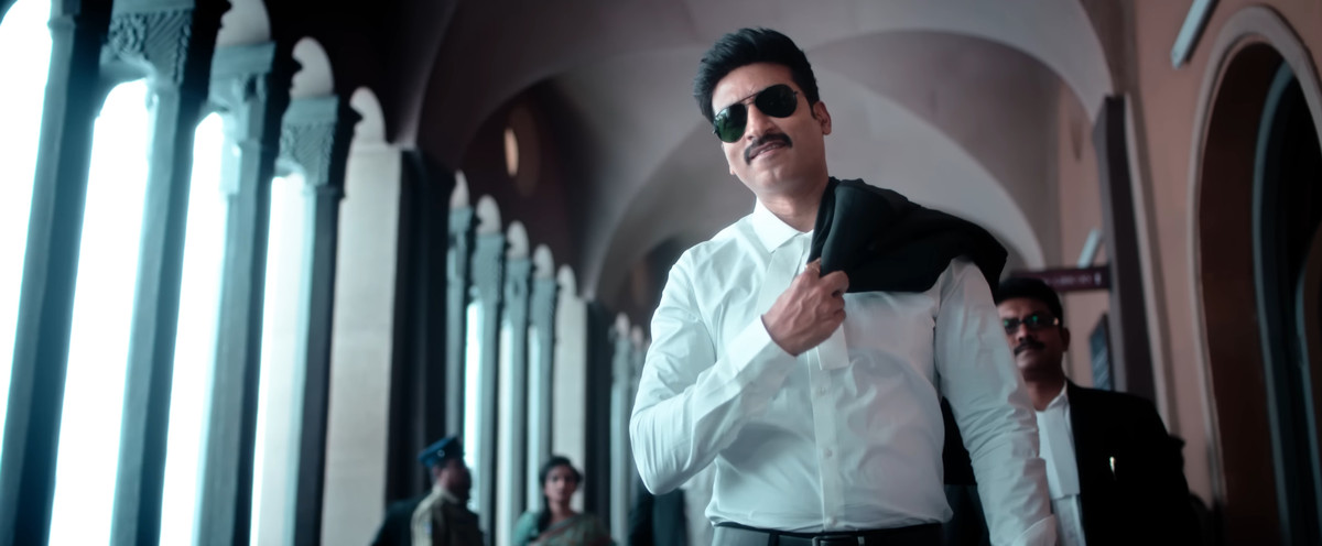 A man wears sunglasses and tosses his coat over his shoulder in Pakka Commercial.