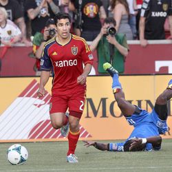 Real Salt Lake's Tony Beltran moves the ball as San Jose's Walter Martinez tumbles in an MLS game between Real Salt Lake and San Jose at Rio Tinto Stadium in Sandy on Saturday, June 1, 2013. RSL beat the Earthquakes 3-0.