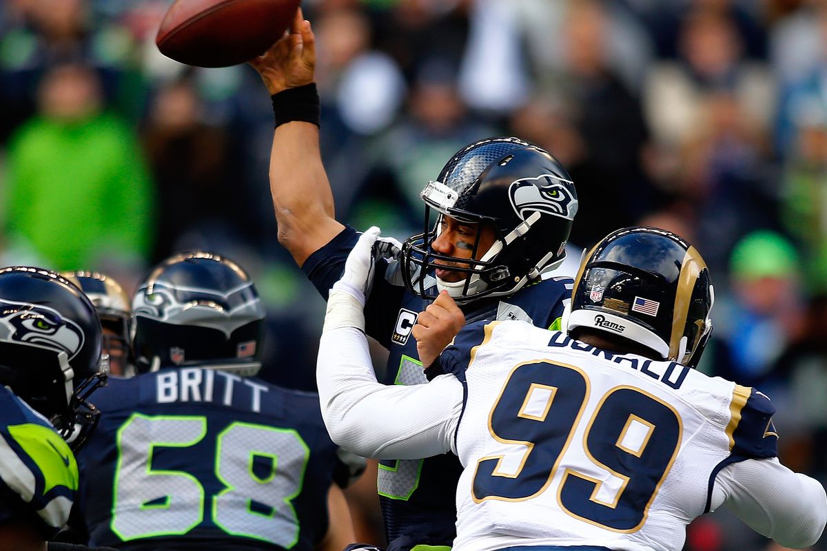 Los Angeles Rams DL Aaron Donald hits Seattle Seahawks QB Russell Wilson