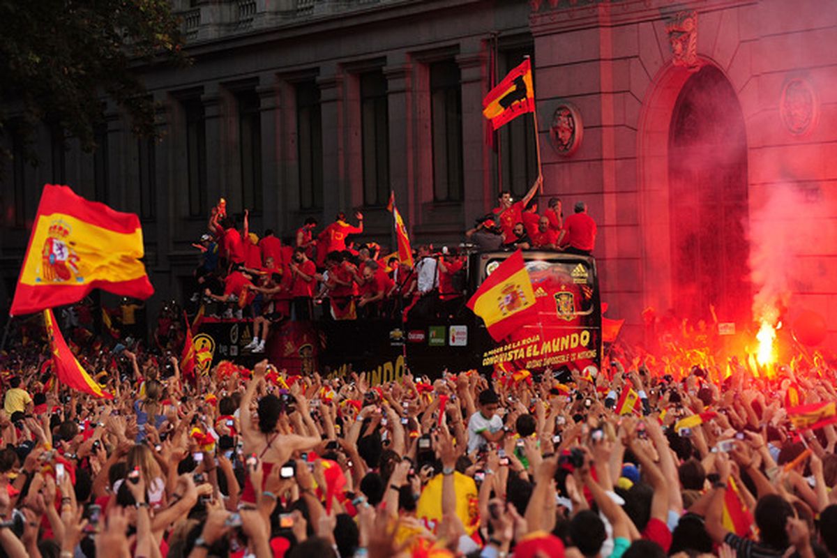 MADRID SPAIN - JULY 12:  Crowds cheer the Spanish team on an open top bus in Plaza Cibeles on July 12 2010 in Madrid Spain after Spain won the FIFA World Cup.  (Photo by Denis Doyle/Getty Images)