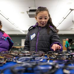Dayra Hurtado Nava, 7, left, and Valeria Diaz, 6, pick out glasses during SightFest at the Jordan School District Auxiliary Services building in West Jordan on Thursday, Dec. 8, 2016. SightFest is a partnership between Friends for Sight and the Utah Optometric Association that on Thursday provided free eye exams and glasses for 125 students from Title I schools in the Jordan School District.