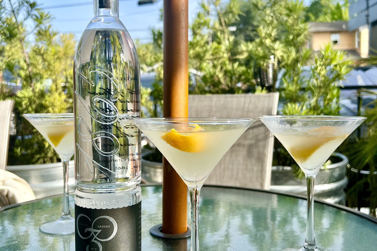 A bottle of General Orders No. 3 vodka with three lemon drop martinis.