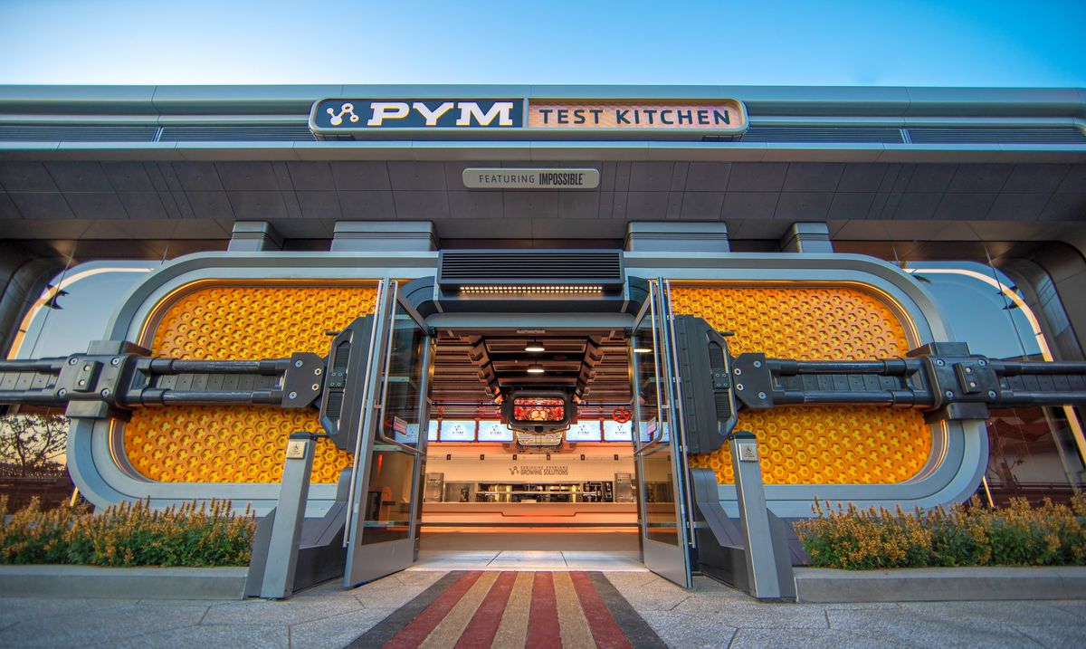 Yellow futuristic doors form the entrance to a futuristic restaurant. 