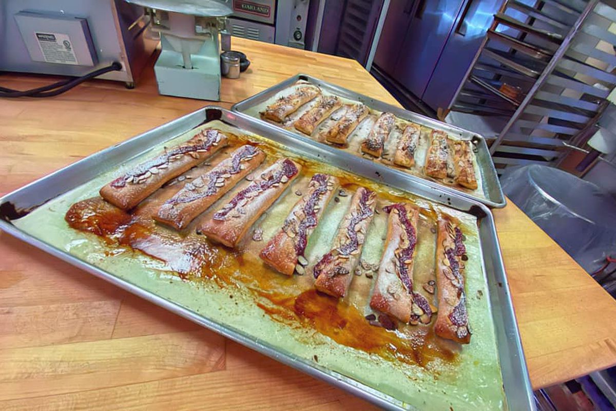 Sugar-coated bread sticks sit on a baking tray right out of the oven at Katsu Burger &amp; Bakery.
