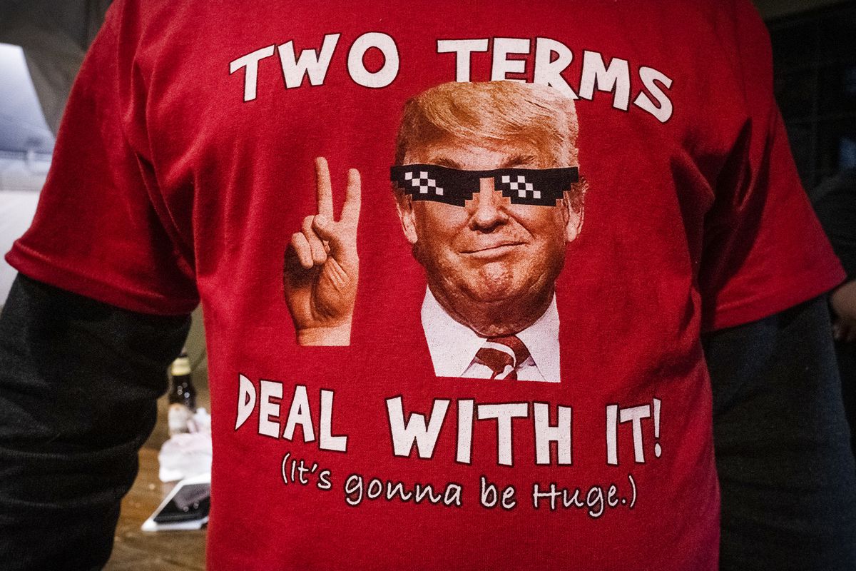 A person wearing a Trump shirt that reads “Two terms. Deal with it.”