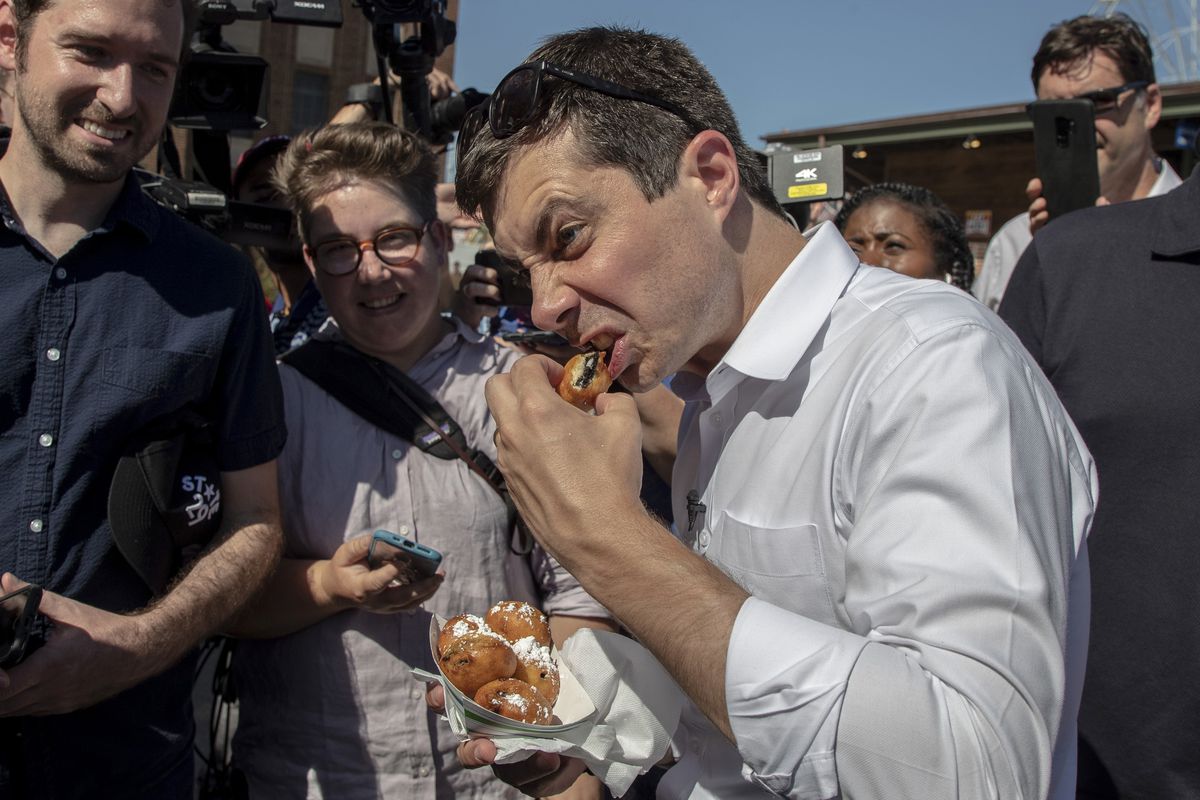 Mayor Pete eats a deep-fried Oreo with an intense facial expression