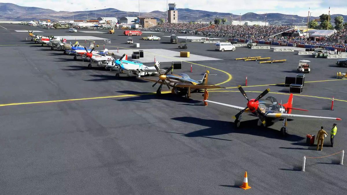 The flight line showing a row of vintage P-51 racing planes.