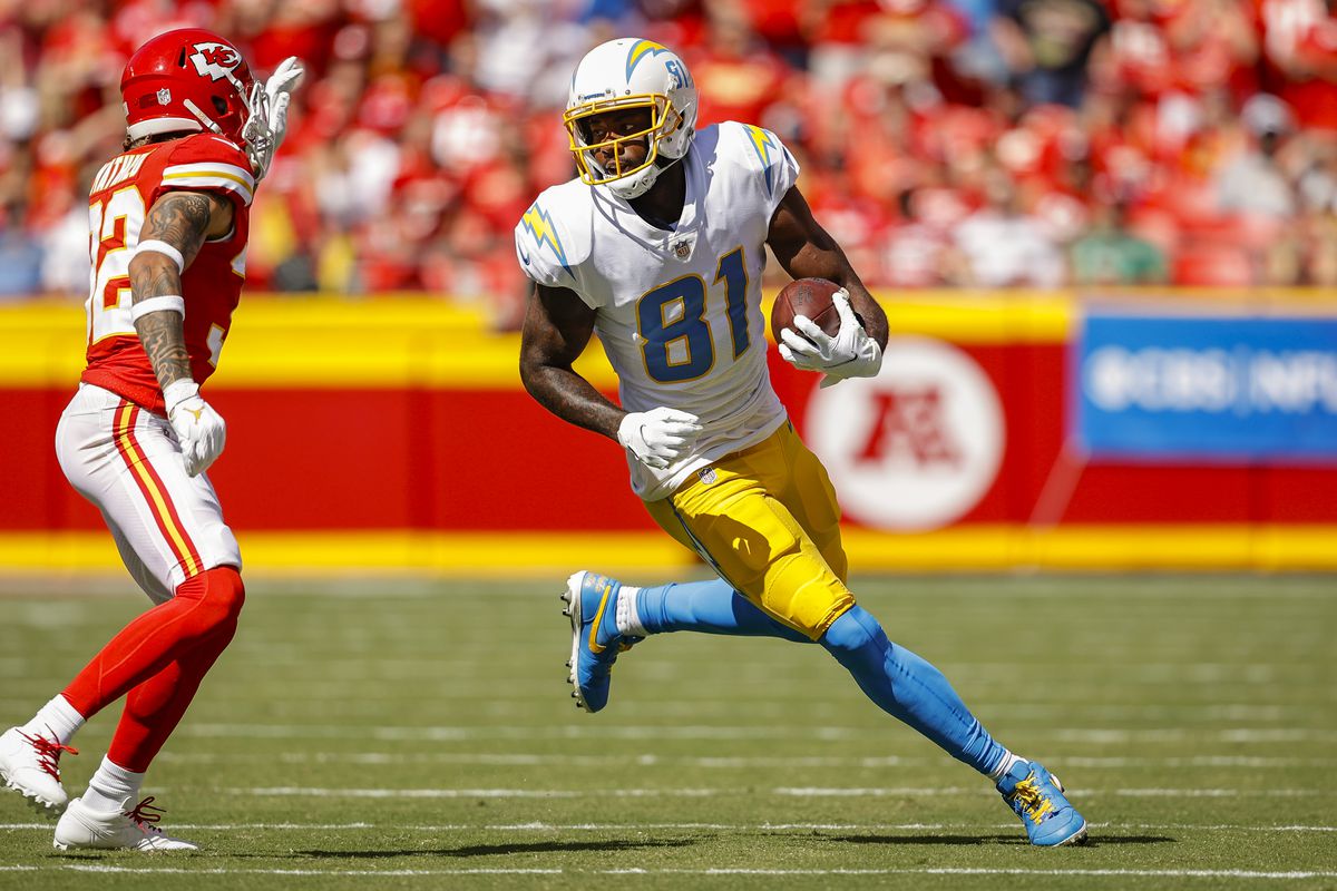 Mike Williams #81 of the Los Angeles Chargers runs with the football during the second quarter away from Tyrann Mathieu #32 of the Kansas City Chiefs at Arrowhead Stadium on September 26, 2021 in Kansas City, Missouri.