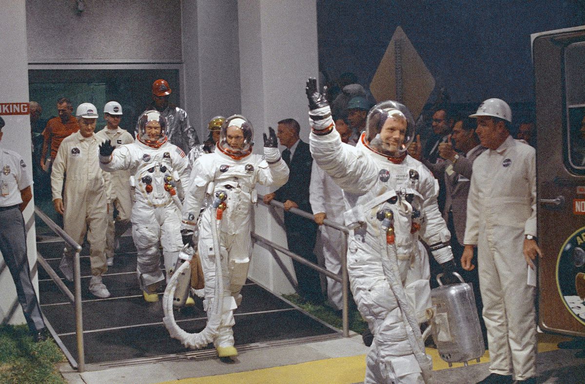 In this July 16, 1969, file photo, Neil Armstrong waving in front, heads for the van that will take the crew to the rocket for launch to the moon at Kennedy Space Center in Merritt Island, Fla. Armstrong commanded the Apollo 11 spacecraft that landed on t