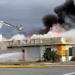 A store on Main Street and 1500 South burns in Salt Lake City on Wednesday, Nov. 18, 2015.  