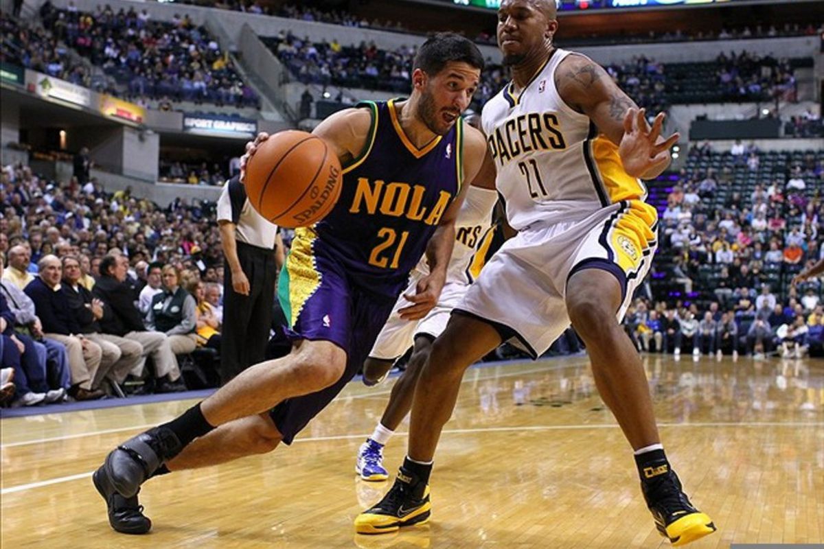 Feb. 21, 2012; Indianapolis, IN, USA; New Orleans Hornets point guard Greivis Vasquez (21) dribbles the ball around Indiana Pacers power forward David West (21) at Bankers Life Fieldhouse. Mandatory credit: Michael Hickey-US PRESSWIRE