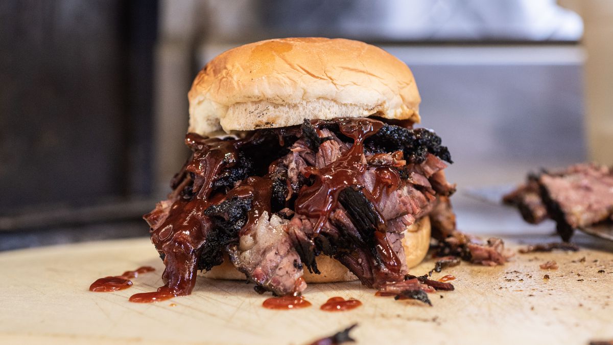The brisket at Rodney’s Ribs is served between plush Hawaiian buns with a drizzle of tangy-sweet sauce.