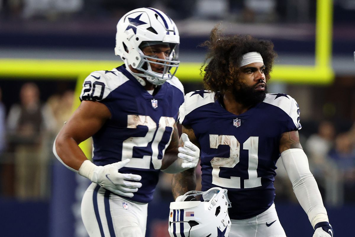 Tony Pollard #20 and Ezekiel Elliott #21 of the Dallas Cowboys stand on the field during the game against the New York Giants at AT&amp;T Stadium on November 24, 2022 in Arlington, Texas.