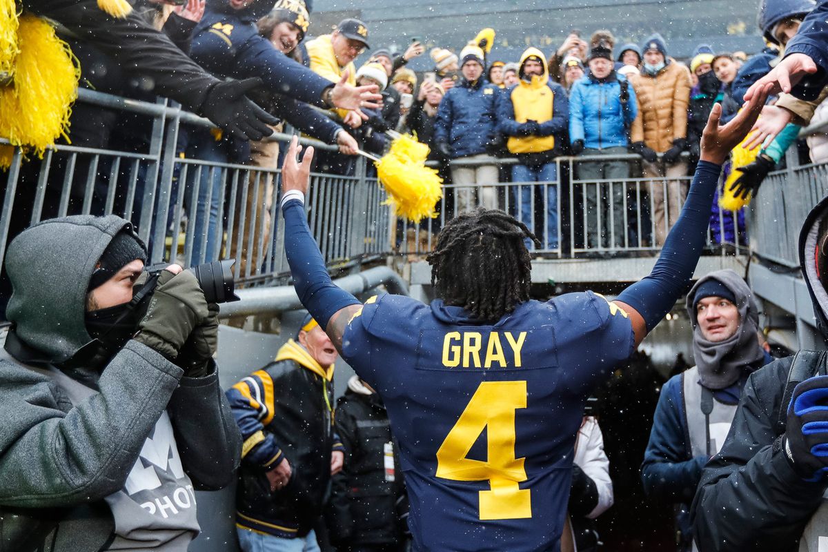 Michigan defensive back Vincent Gray (4) waves at fans as he walks up the tunnel after the Wolverines won 42-27 against Ohio State at Michigan Stadium in Ann Arbor on Saturday, Nov. 27, 2021.