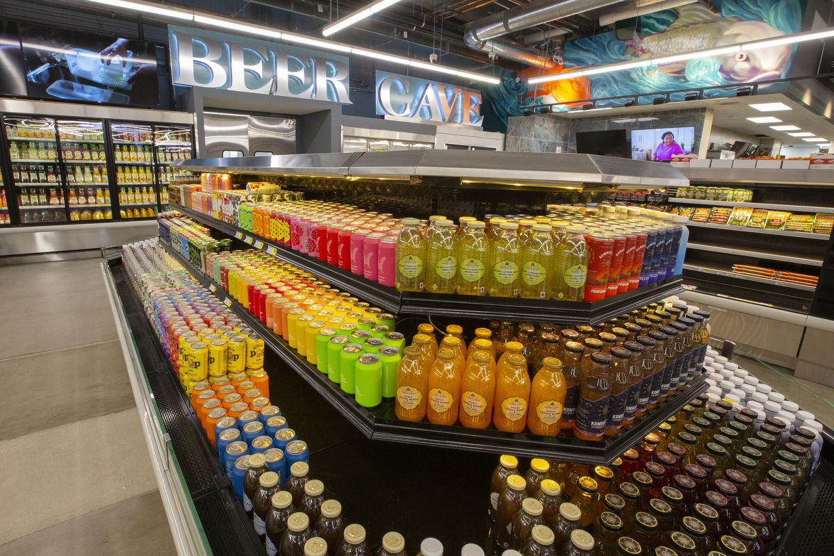 A large grocery store section filled with bottled drinks.