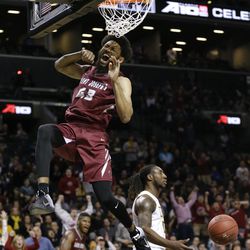 Saint Joseph's forward DeAndre Bembry (43) reacts after dunking against Virginia Commonwealth late in the second half of an NCAA college basketball game during the championship game of the Atlantic 10 men's tournament, Sunday, March 13, 2016, in New York.  
