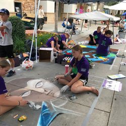 Artists at work on their pieces during the 2018 Utah Foster Care Chalk Art Festival.