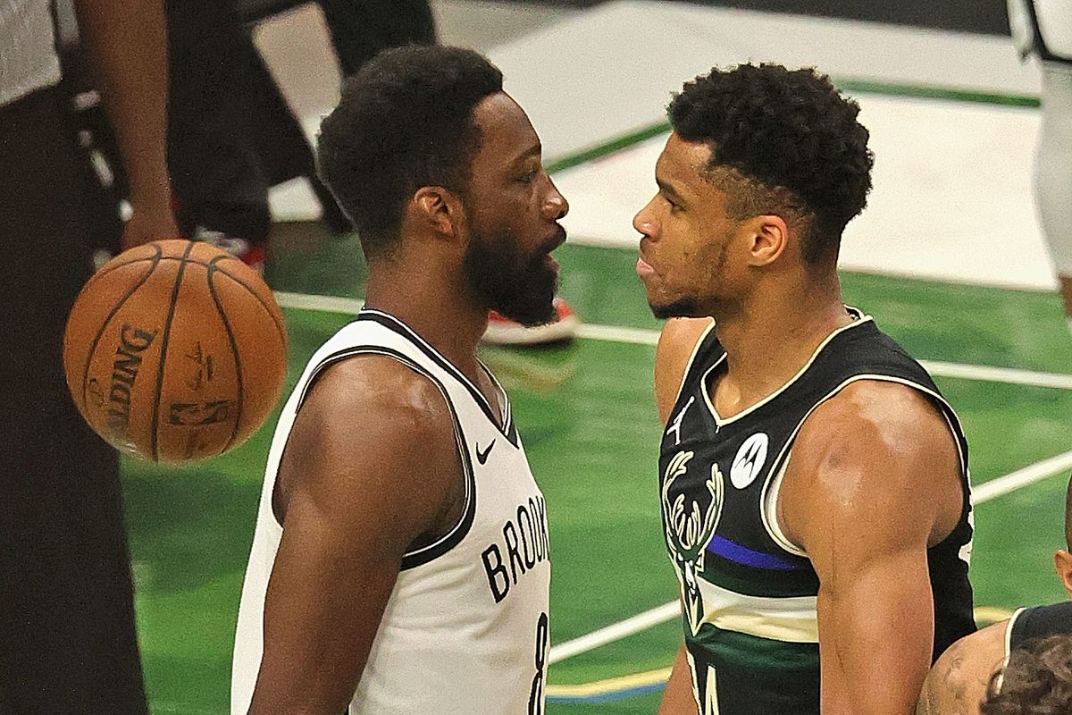 Giannis Antetokounmpo #34 of the Milwaukee Bucks stares down Jeff Green #8 of the Brooklyn Nets after dunking on him at Fiserv Forum on June 17, 2021 in Milwaukee, Wisconsin. The Bucks defeated the Nets 104-89.