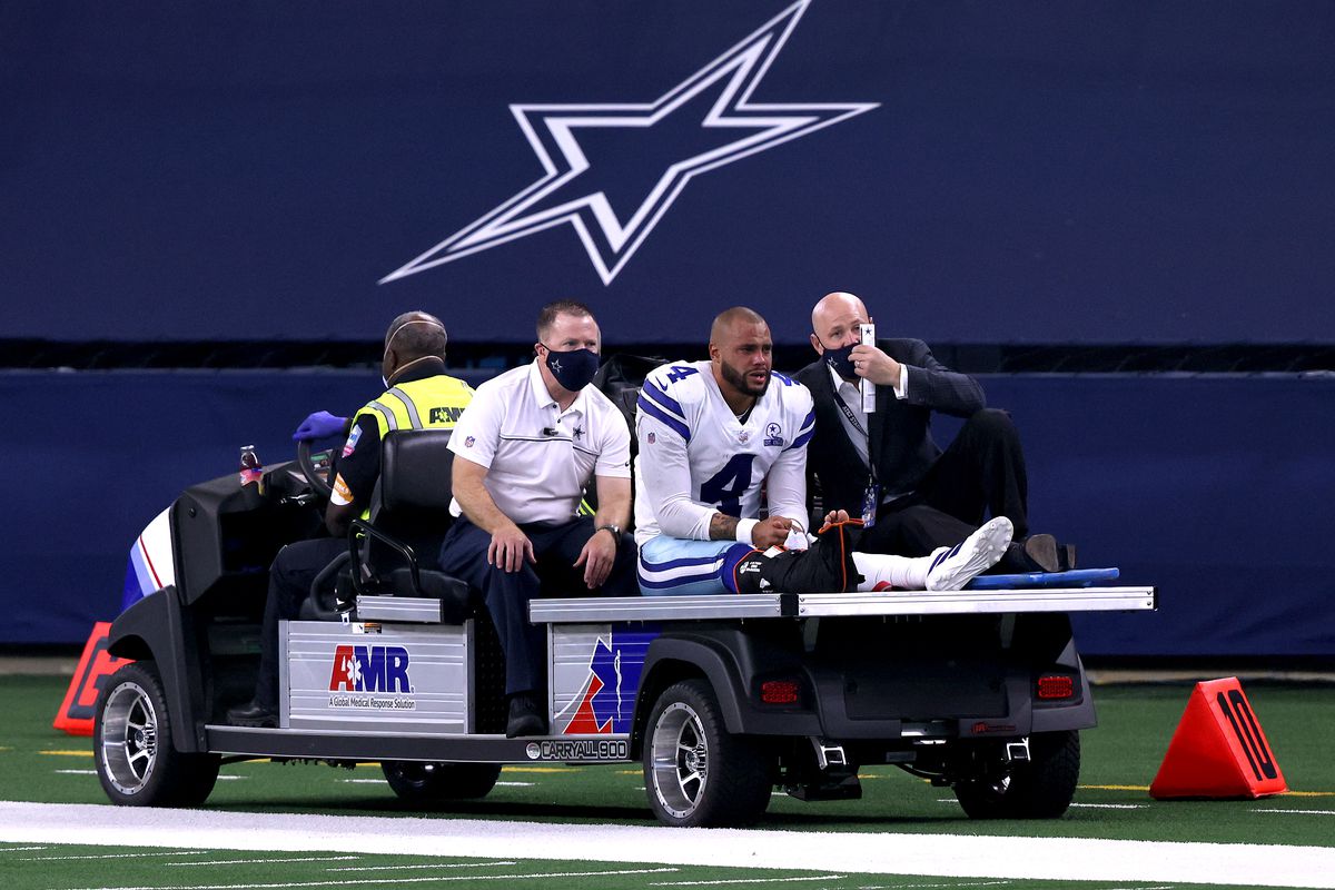 Dak Prescott #4 of the Dallas Cowboys is carted off the field after sustaining a leg injury against the New York Giants during the third quarter at AT&amp;T Stadium on October 11, 2020 in Arlington, Texas.