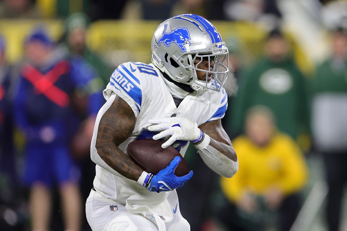 Jamaal Williams #30 of the Detroit Lions runs for yards during a game against the Green Bay Packers at Lambeau Field on January 08, 2023 in Green Bay, Wisconsin. The Lions defeated the Packers 20-16.
