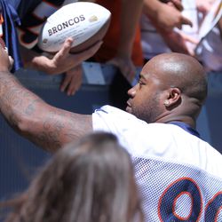 Broncos DT Kevin Vickerson hands a feshly autographed football to a fan