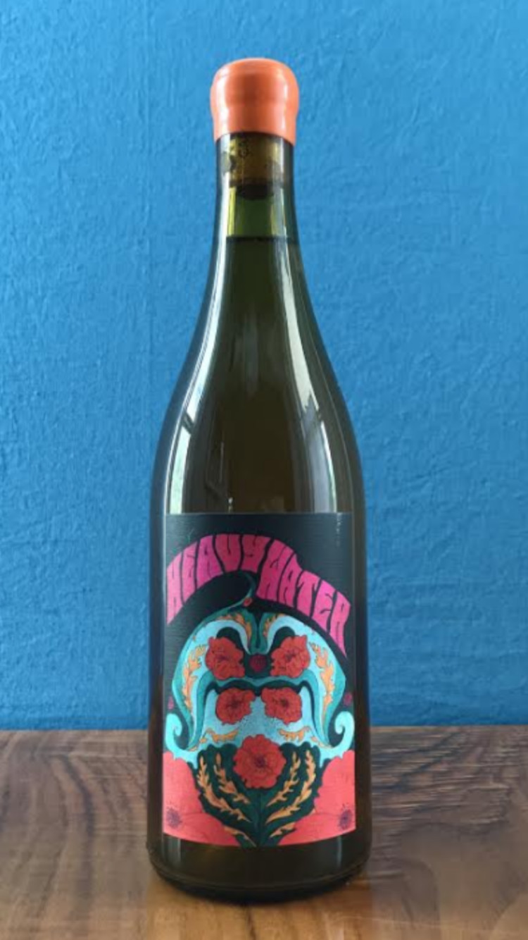 A bottle of 2020 Heavy Water, which is decorated with a blue-and-red abstract design.