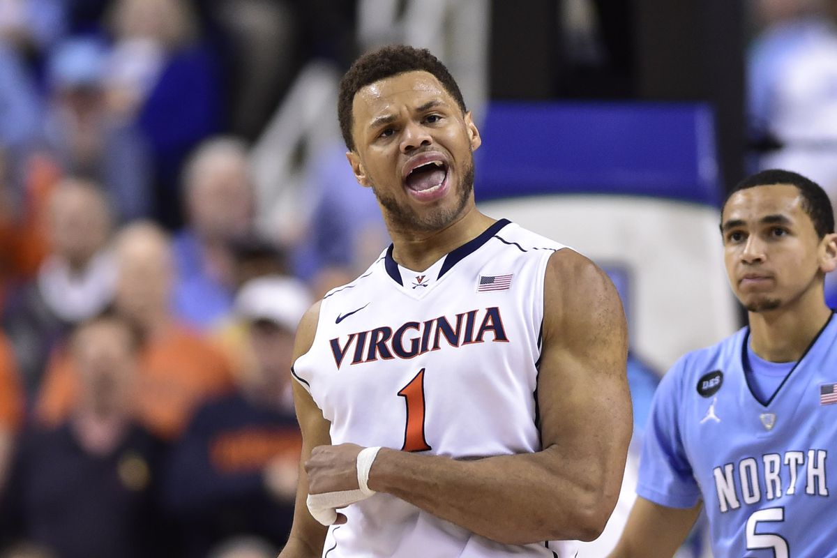 Mar 13, 2015; Greensboro, NC, USA; Virginia Cavaliers guard Justin Anderson (1) and North Carolina Tar Heels guard Marcus Paige (5) react in the second half. The Tar Heels defeated the Cavaliers 71-67 in the semifinals of the ACC Tournament 
