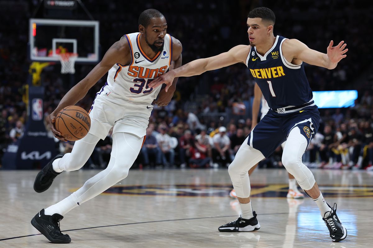 DENVER, COLORADO - MAY 01: Kevin Durant #35 of the Phoenix Suns drives against Michael Porter Jr. #1 of the Denver Nuggets in the second quarter during Game Two of the NBA Western Conference Semifinals at Ball Arena on May 01, 2023 in Denver, Colorado.