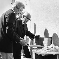 Arthur Moore hands a trowel to President Spencer W. Kimball at the cornerstone ceremony in August 1981.