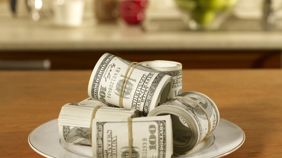 A plate stacked with rolls of cash.
