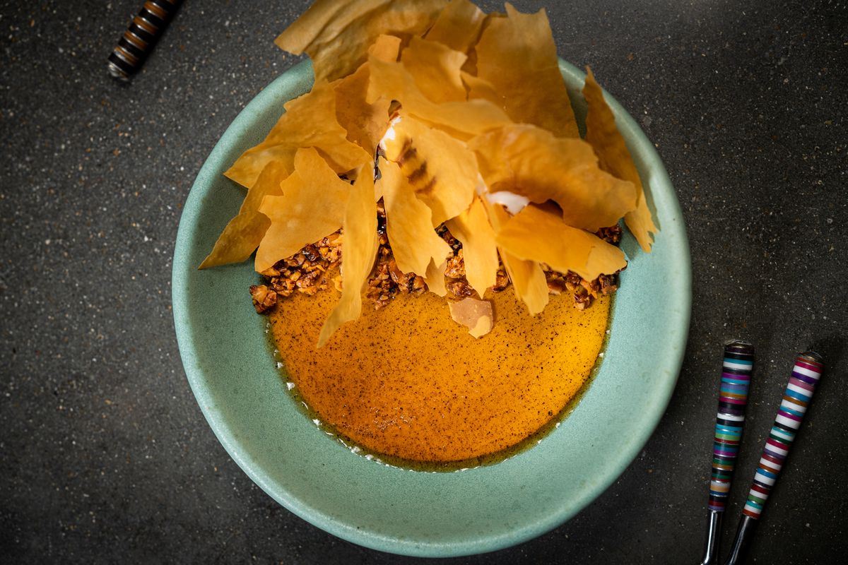 A “baklava” dessert at Albi pairs cinnamon custard with walnut honey ice cream and phyllo shards.