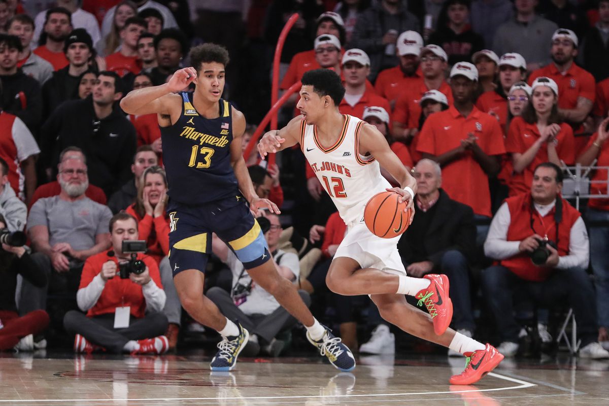 St. John’s Red Storm guard RJ Luis Jr. (12) looks to drive past Marquette Golden Eagles forward Oso Ighodaro (13) in the first half at Madison Square Garden. Mandatory Credit: Wendell Cruz