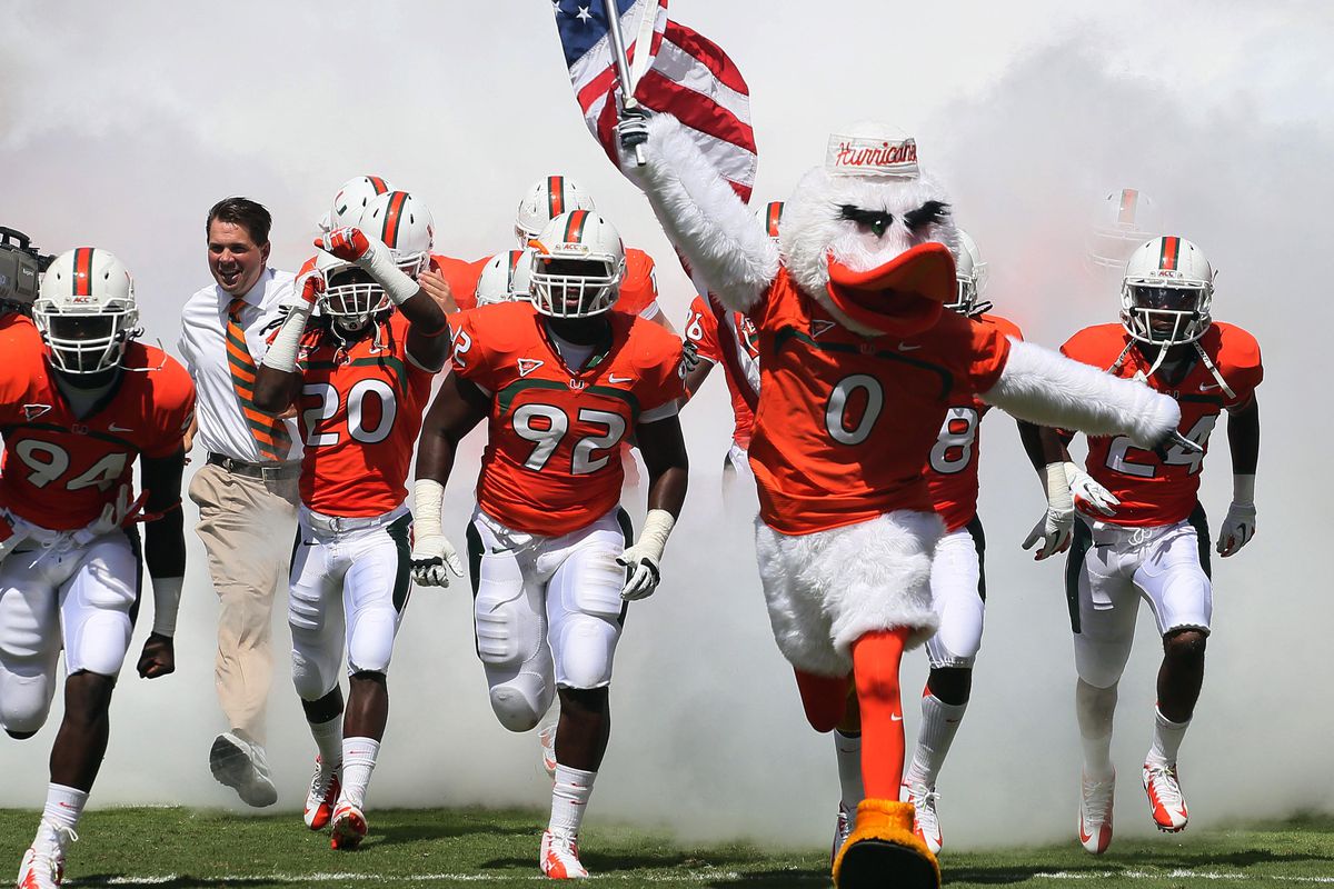 Sept 15 2012; Miami Gardens, FL, USA;  Miami Hurricanes mascot Sebastian the Ibis, players and head coach Al Golden enter the field before a game against the Bethune Cookman Wildcats at Sun Life Stadium. Mandatory Credit: Robert Mayer-US PRESSWIRE