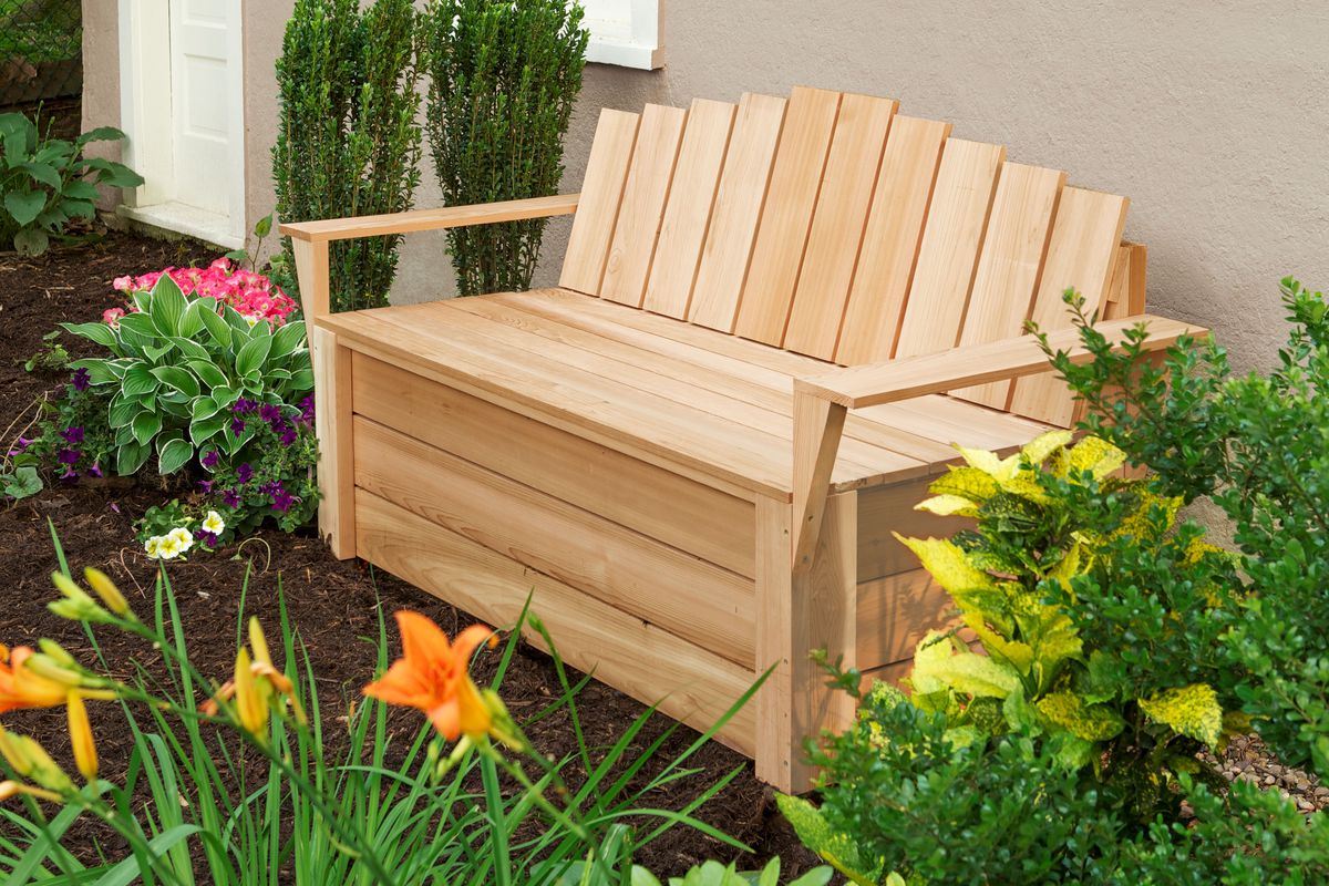 A cedar compost bench in a landscaped garden
