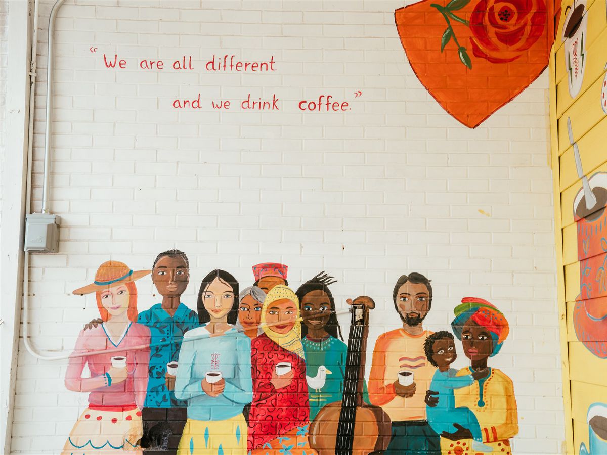 A mural featuring people of different cultures drinking coffee, beneath the words “We are all different / and we drink coffee”