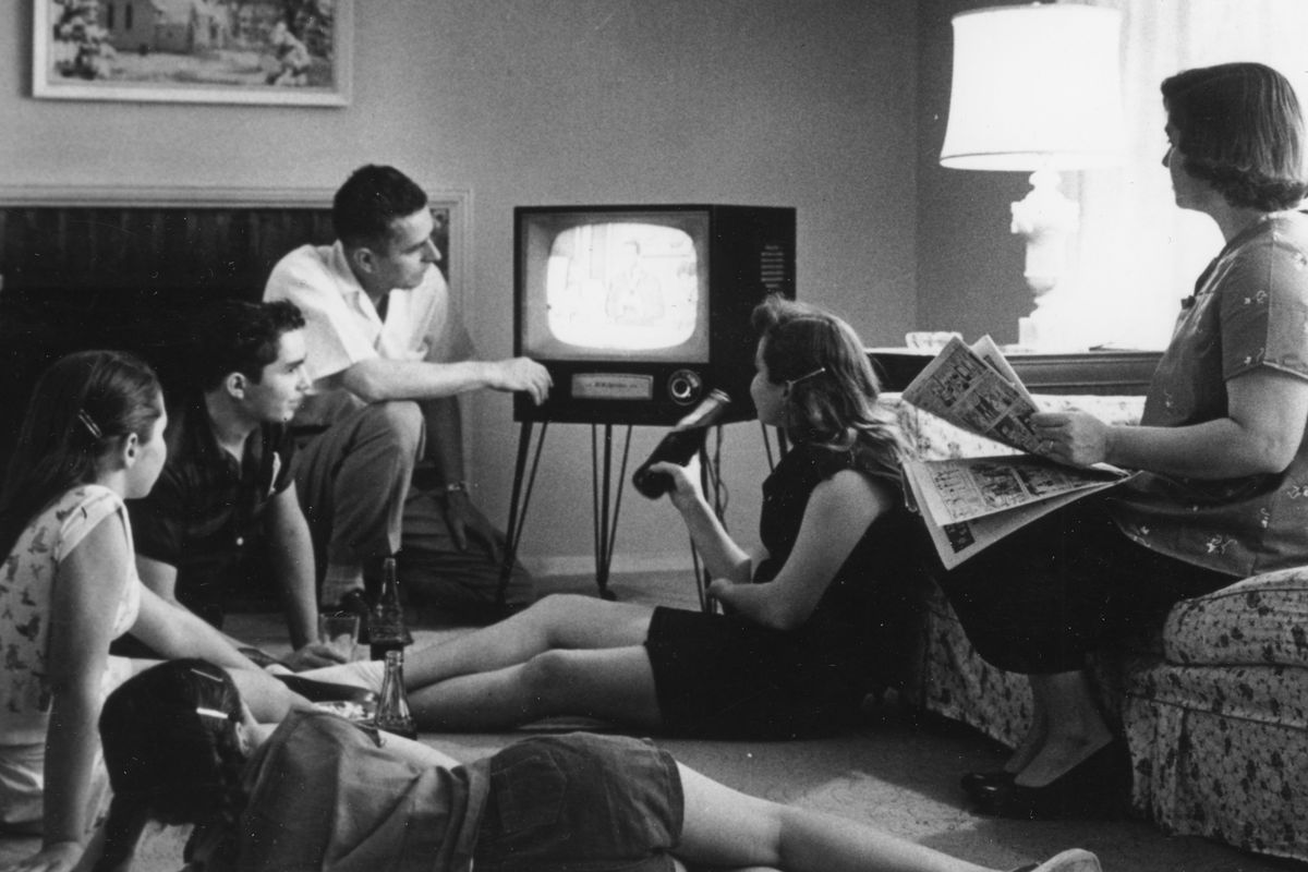 Family Watching Television At Home