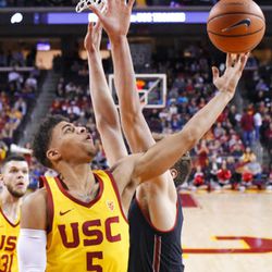 Southern California guard Derryck Thornton, left, shoots as Utah forward Jayce Johnson defends during the first half of an NCAA college basketball game, Sunday, Jan. 14, 2018, in Los Angeles. (AP Photo/Mark J. Terrill)