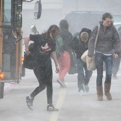 Students fight the wind and blowing snow as they arrive at Farmington Junior High School in Farmington, Tuesday, April 9, 2013.