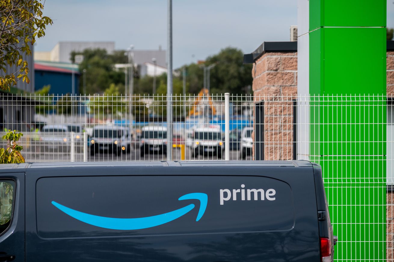 Amazon van with prime logo in a logistic centre. Amazon has...
