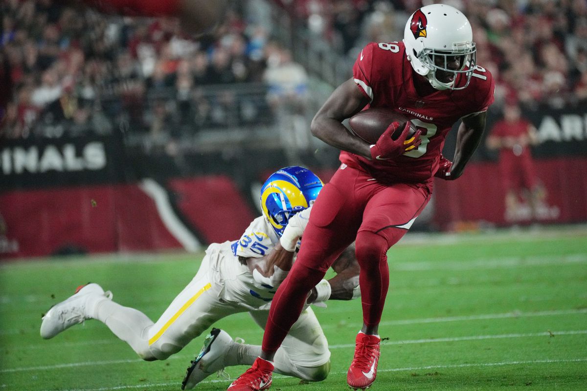 Arizona Cardinals wide receiver A.J. Green (18) breaks a tackle by Los Angeles Rams defensive back Kareem Orr (35) during the first quarter at State Farm Stadium.
