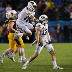 Brigham Young Cougars defensive back Kai Nacua (12) celebrates his game-winning interception against the Wyoming Cowboys during the Poinsettia Bowl in San Diego on Wednesday, Dec. 21, 2016. BYU won 24-21.